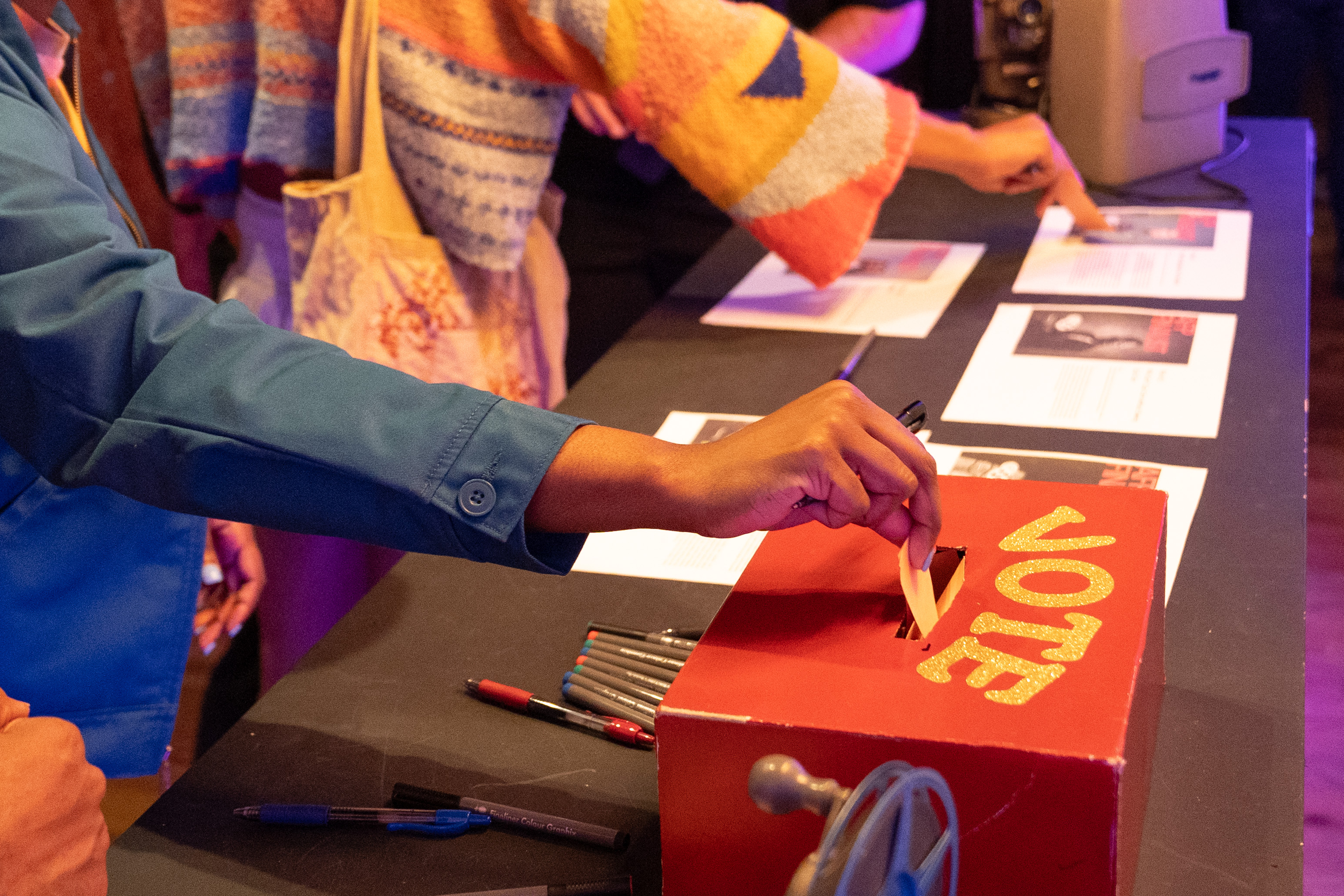 Event attendee placing their vote for best film into the event's ballet box